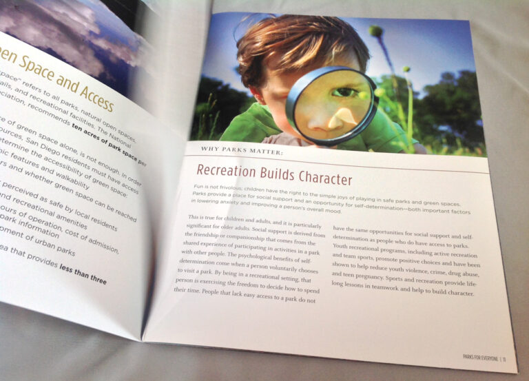 A book with an image of a child looking through a magnifying glass.
